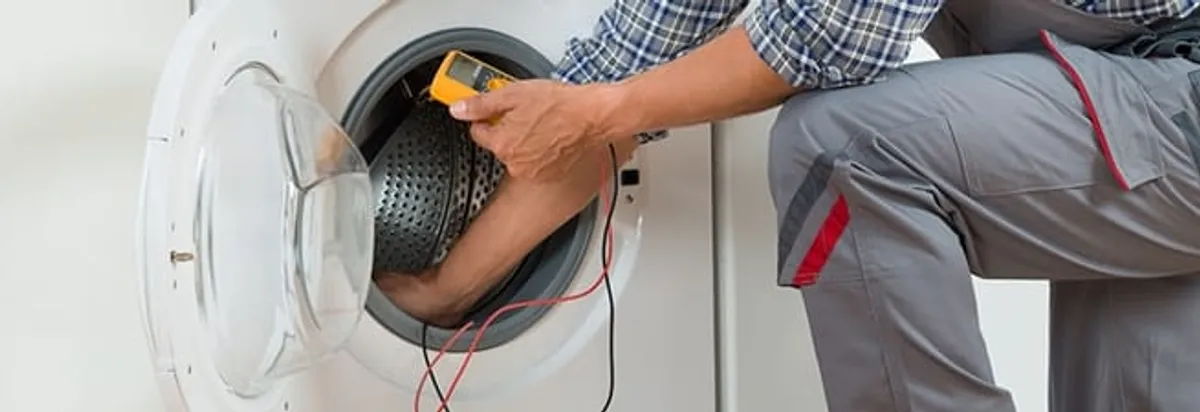 Dryer repair technician inspecting and repairing a clothes dryer in Milwaukee, WI