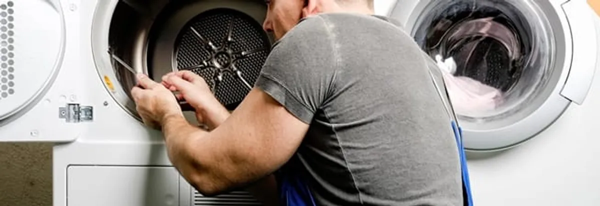 Dryer repair technician fixing a clothes dryer drum in Milwaukee, WI