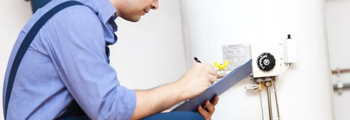 Water heater repair technician inspecting the unit and recording service notes in Milwaukee, WI
